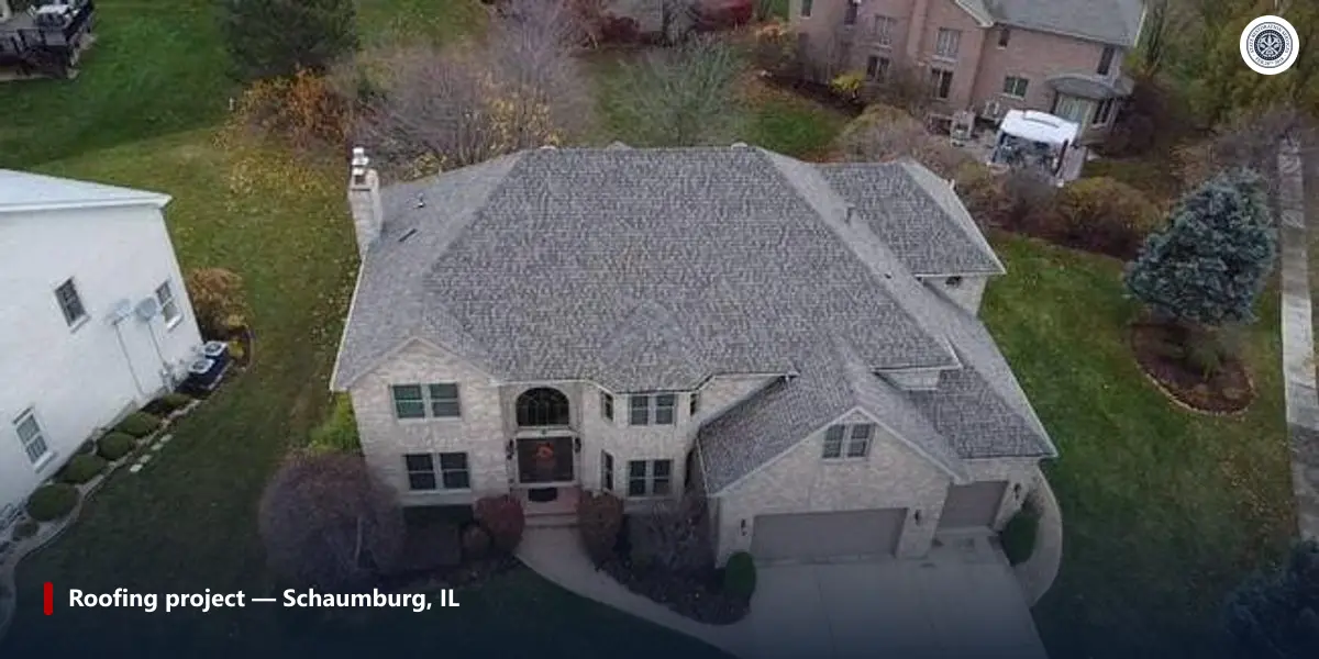 Aerial view of a completed asphalt shingle roof with continuous ridge venting on a Chicago-area home