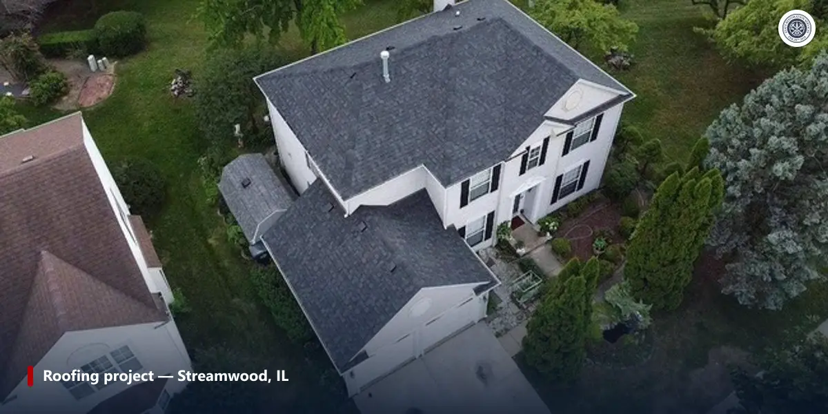 Aerial view of a completed gray architectural shingle roof on a two-story home in Streamwood, Illinois