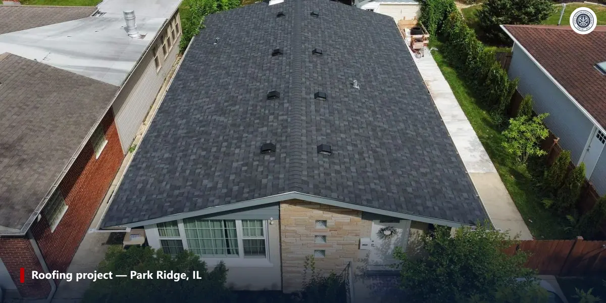 Aerial view of a charcoal asphalt shingle roof with box vents on a house in Park Ridge, Illinois