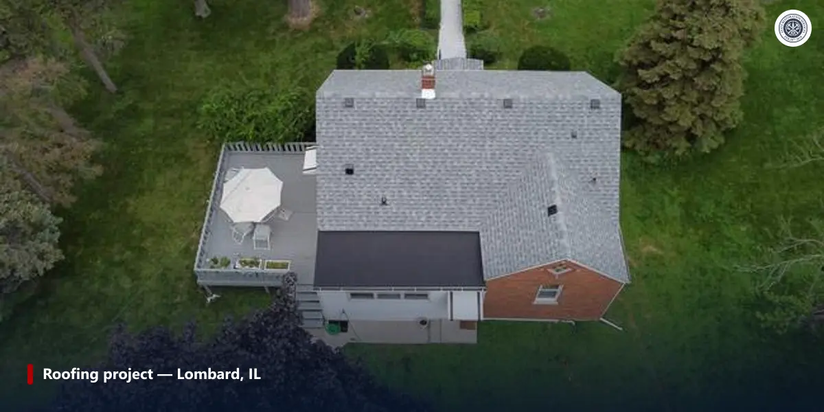 Aerial view of a completed grey shingle roof and low-slope garage section in Lombard, Illinois