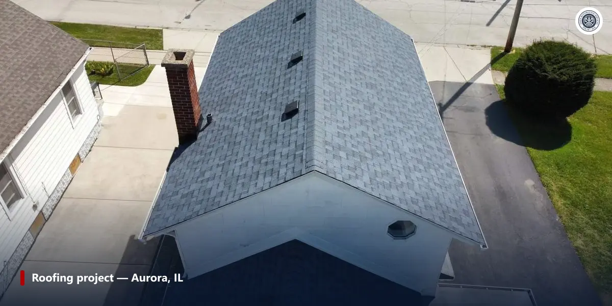 Aerial view of a completed shingle roof with three vent caps spaced along the rear slope