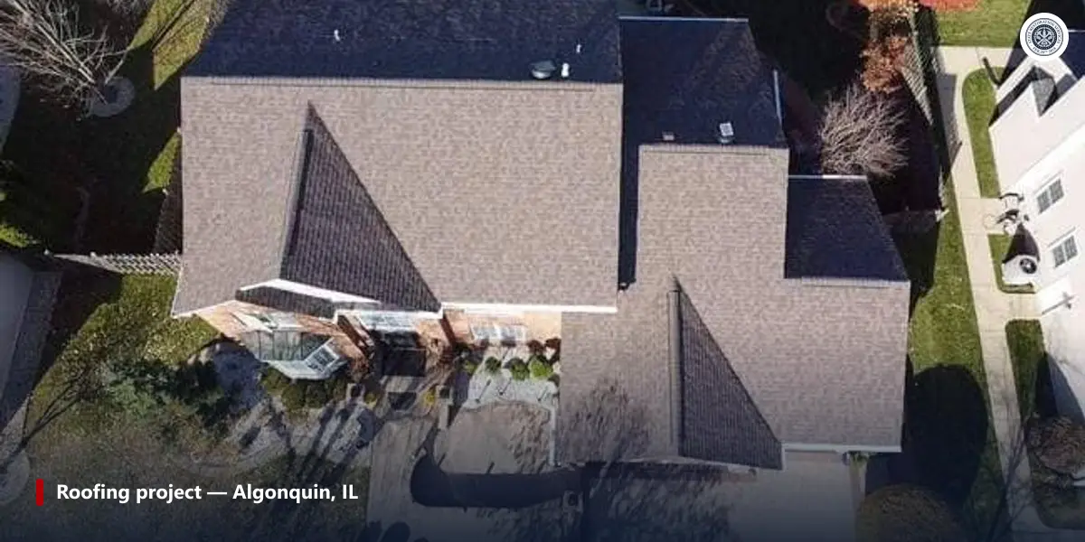 Aerial view of a finished shingle roof in Algonquin, IL, showing vent pipes, valleys and two lower roof sections