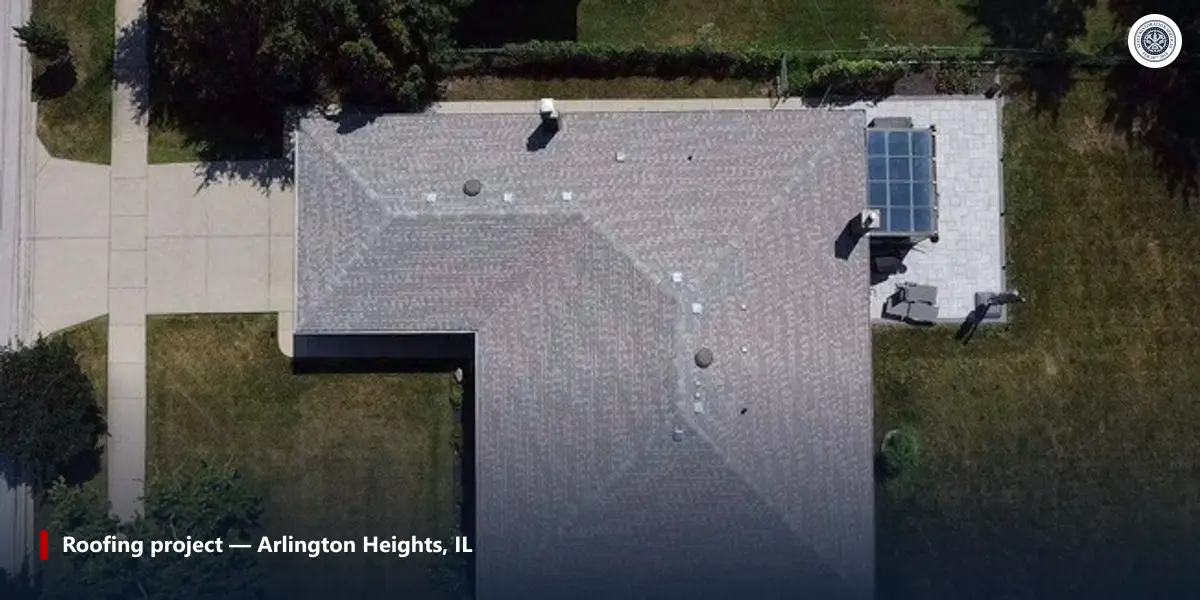 Aerial view of a gray shingle hip roof with its eaves, roof vents and a sunroom on a house in Arlington Heights, Illinois