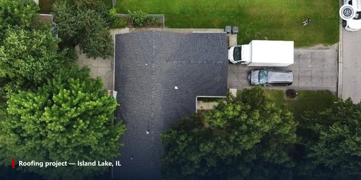 Aerial photo of a completed shingle roof with the work truck still on the driveway, Island Lake, Illinois.