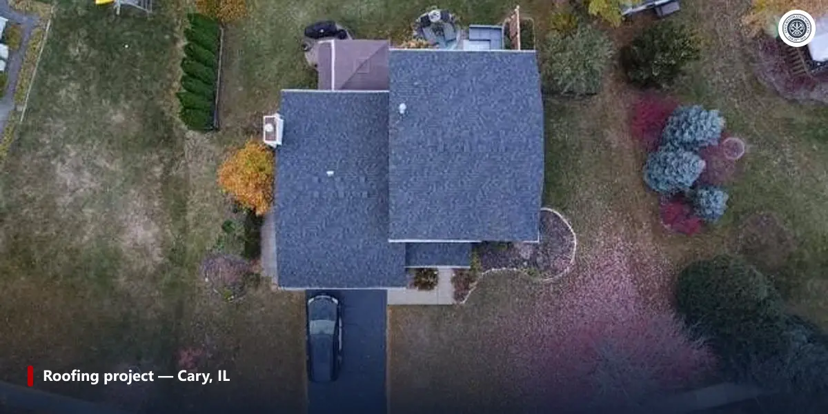 Aerial view of a house in Cary, IL, with lower roof sections meeting taller walls after a roof replacement