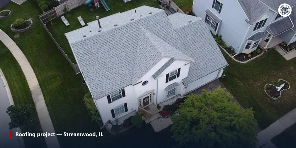 Aerial view of a two-story white house with a light gray shingle roof and straight roof edges, Streamwood, IL