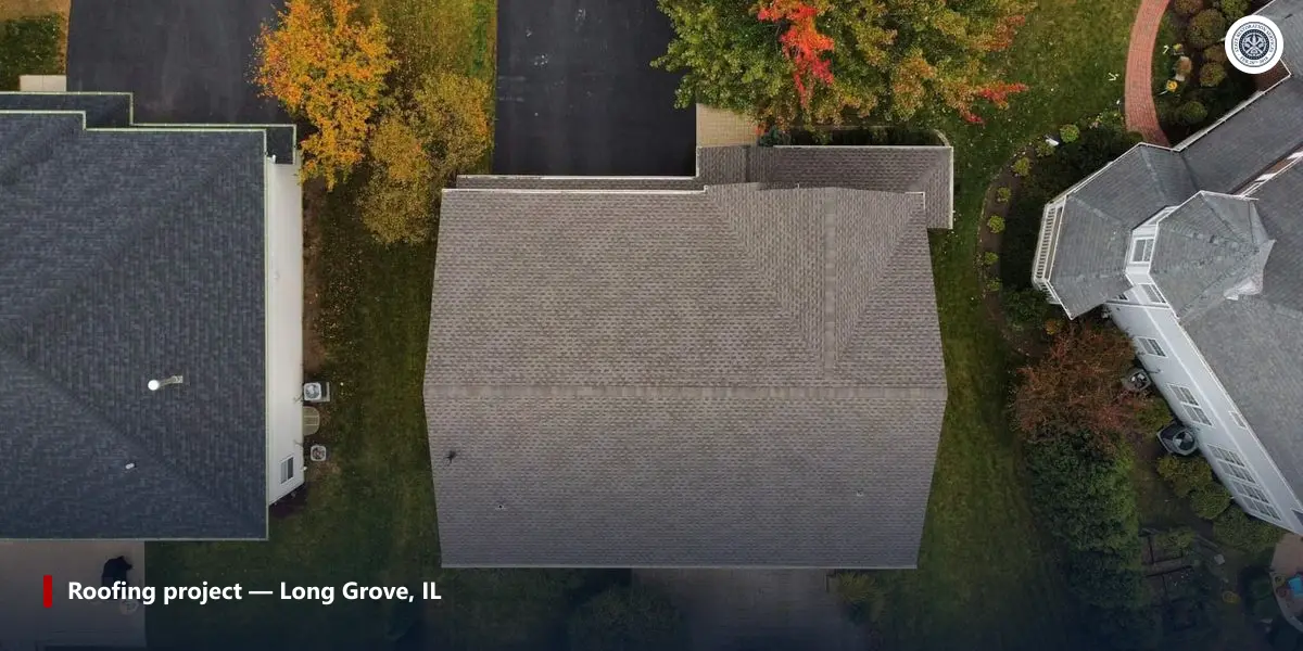 Aerial view of a finished asphalt shingle roof on a two-story house in Long Grove, Illinois, with autumn trees and neighbouring roofs
