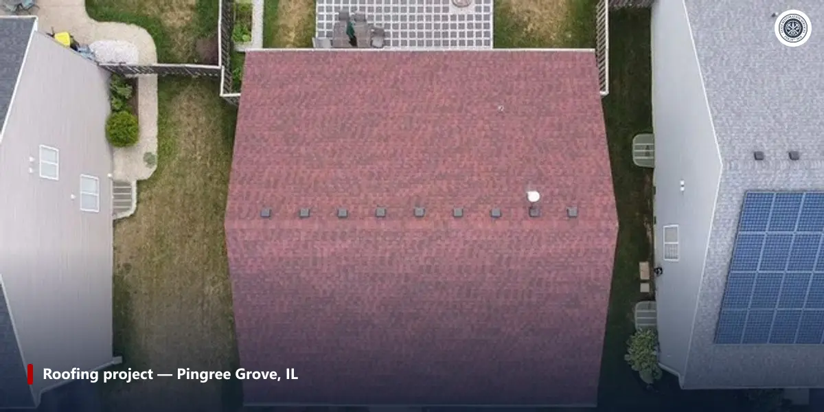 Aerial view of a red shingle roof with narrow grass side yards between it and the neighbouring houses