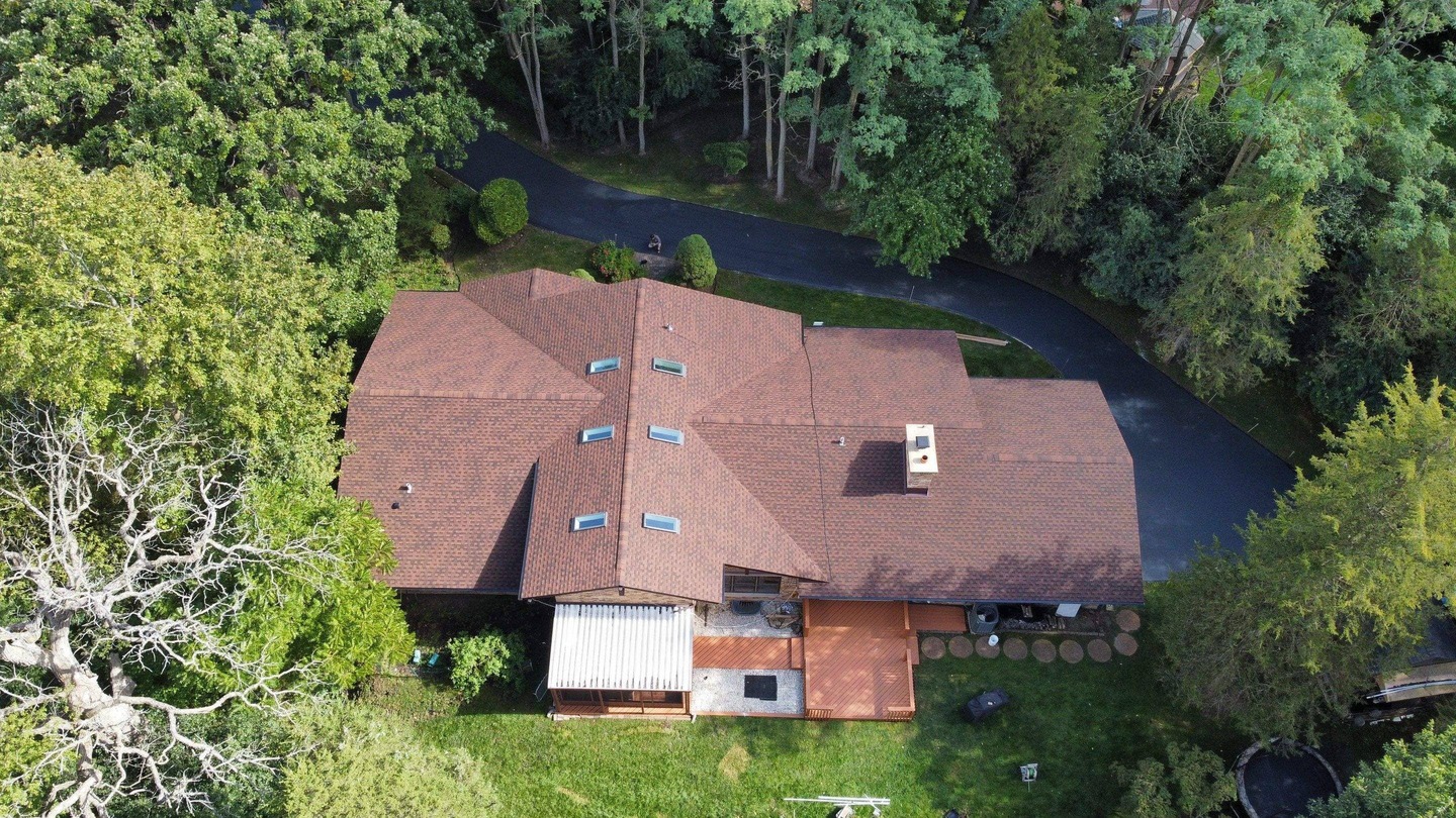 Aerial view of the roof installed by State Restoration Services for the Wild Woods Project, blending seamlessly with the natural surroundings.