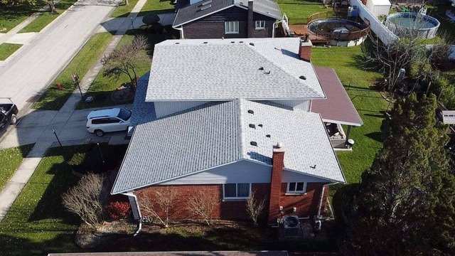 Drone shot of the Grey Roof over the Red Brick house, installed by State Restoration Services, showcasing the striking contrast and precise craftsmanship.