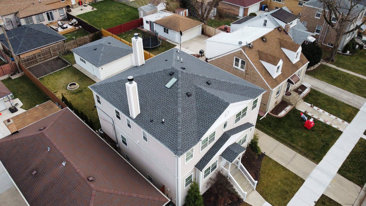 Drone view of the Silver Castle Project roof by State Restoration Services, shining with a sleek finish and reflecting expert craftsmanship.