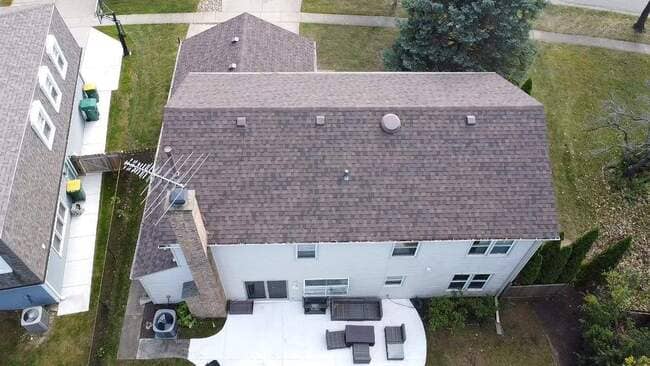 Close-up low-resolution view of a newly installed residential asphalt shingle roof featuring clean lines and professional installation standards, highlighting a completed roofing project.