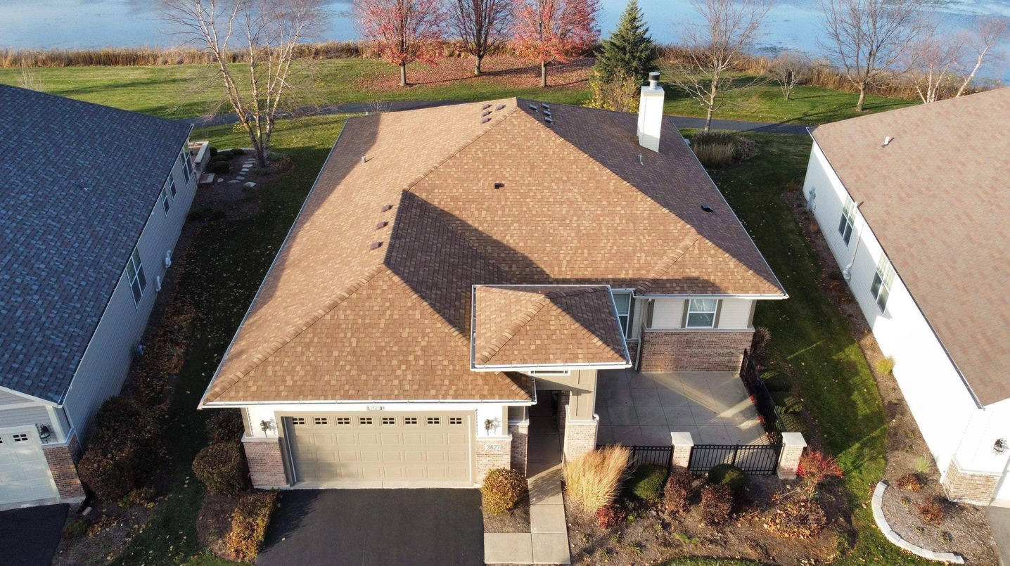 Drone view of a newly installed roof by State Restoration Services, highlighting the roofing company's expert craftsmanship and durable design.