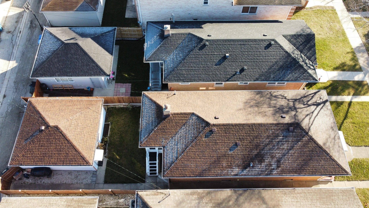 Drone shot of the roof built by State Restoration Services during the 'Last Project of the Year,' with icy drops adding a stunning finish to the completed work.