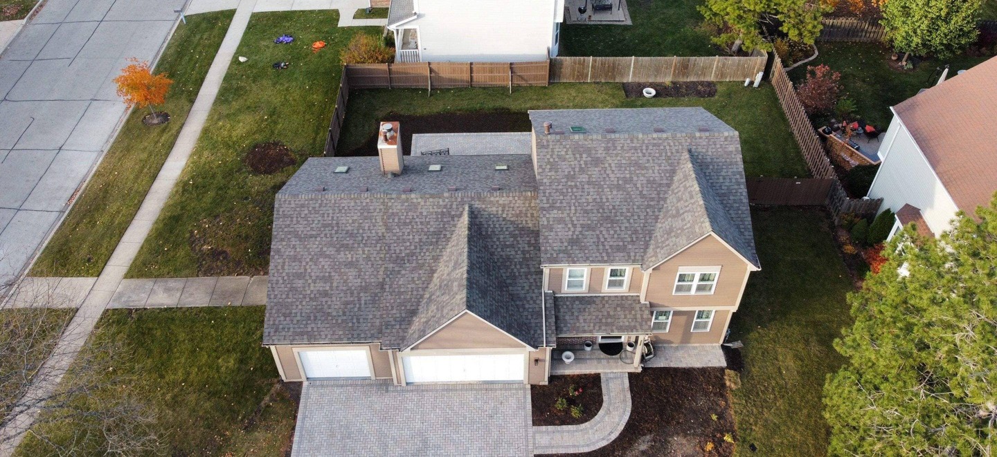 Drone view of a complete re-roof with new skylights by State Restoration Services, capturing the sleek design and expert installation.