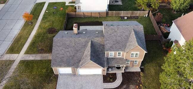 Aerial overhead view of a completed residential asphalt shingle roof featuring clean architectural lines, precise hip and ridge caps, and integrated roof vents. The professional roofing system demonstrates durable, high-quality installation standards.  3. Helpful, Keyword-Rich Caption for Yelp (Max 130 Characters)